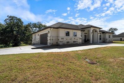 The wrap around driveway guides you to a 2-car garage and more driveway space on the side of the home. | Image 3