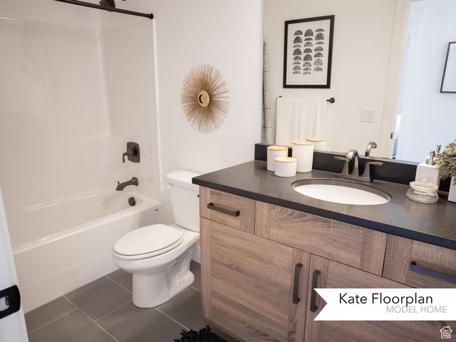 Full bathroom with vanity, tile patterned flooring, toilet, and shower combination | Image 9