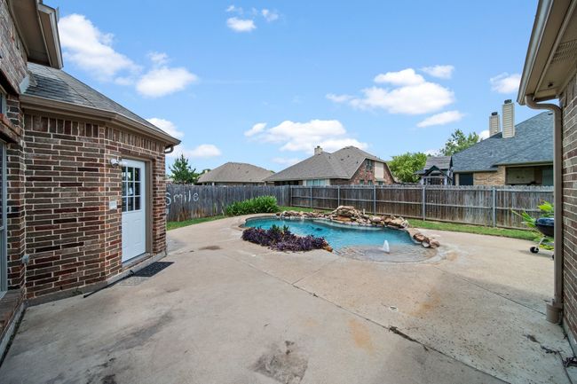 View of pool with a fenced backyard, a fenced in pool, and a patio area | Image 37
