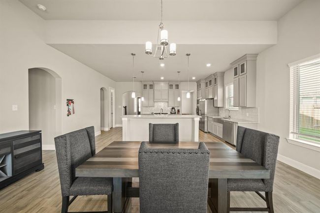 Large windows brighten the dining space and offer views of the backyard. | Image 12