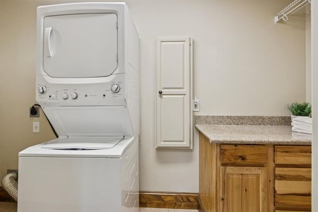 Laundry room on the 1st floor with built in cabinet. There is plenty of room for standard washer & dryer with both electric and gas dryer connections. | Image 34