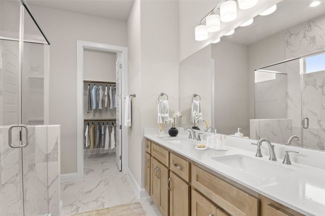 Full bath with marble finish floors, a marble finish shower, double vanity, baseboards, and a spacious closet | Image 26