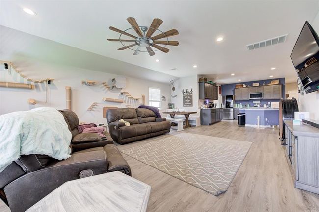 Living area featuring a ceiling fan, light wood-type flooring, and recessed lighting | Image 7
