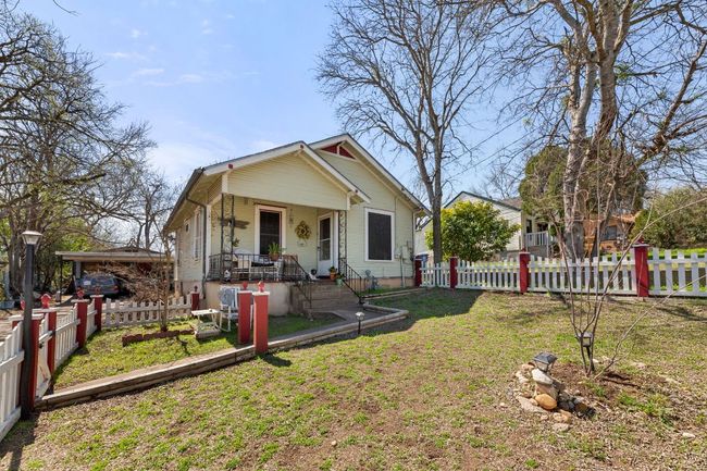Bungalow with a porch, fence private yard, and a front yard | Image 35