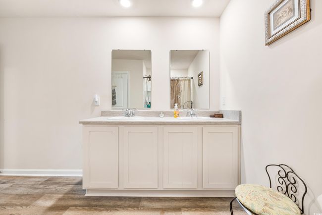 Corridor featuring light wood-type flooring, a sink, and baseboards | Image 30