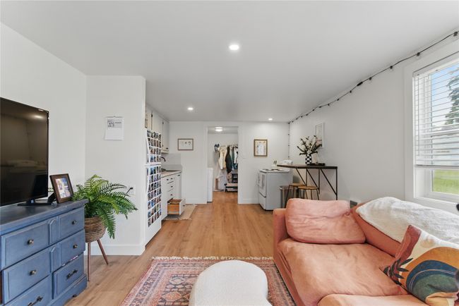 Living room featuring recessed lighting, baseboards, light wood finished floors, and washer and dryer | Image 24