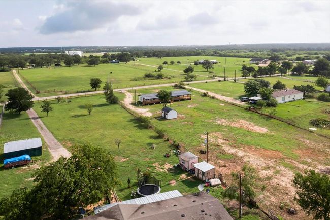Aerial view of sparsely populated area featuring land | Image 37
