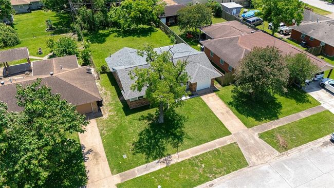 This elevated front view captures the long driveway, neat walkways, and a clear look at the lot’s generous size. | Image 38