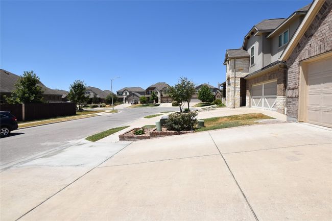 View of neighboring homes and street in great Sunfield neighborhood. | Image 37