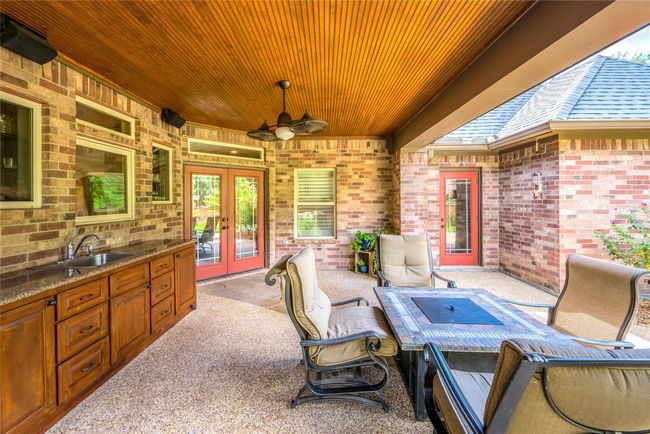 This inviting porch features a sink and cabinetry, with direct access from the living room and primary bedroom. An adjacent 300 sqft patio offers a perfect space for outdoor entertaining. | Image 39
