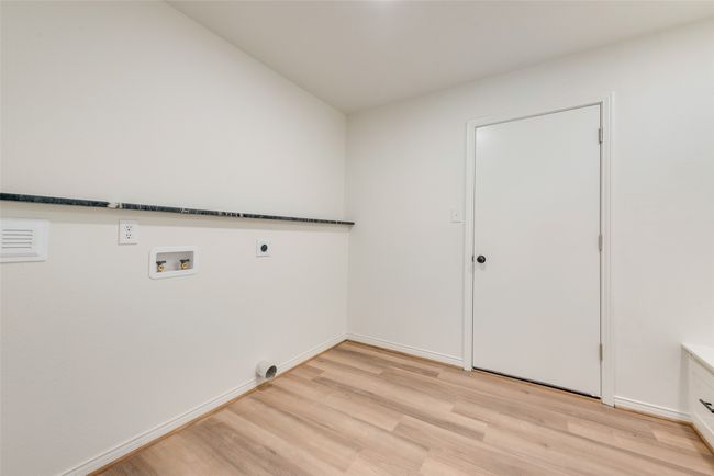 Laundry room featuring electric dryer hookup, light wood-style flooring, and washer hookup | Image 16