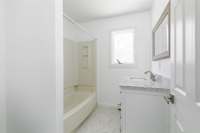 Full bath with shower / washtub combination, vanity, and baseboards | Image 12