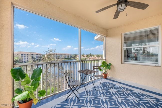 Covered, screened lanai with a water view and ceiling fan | Image 20