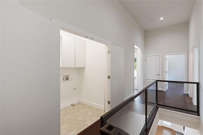 Hall with baseboards and light tile patterned flooring | Image 25