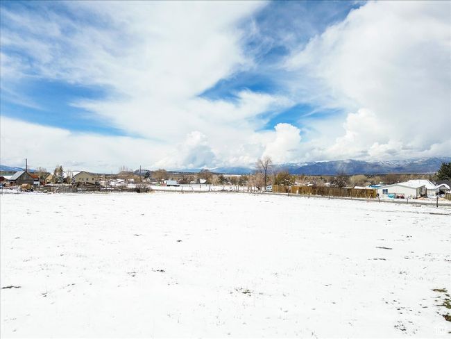 Yard covered in snow with a mountain view | Image 12