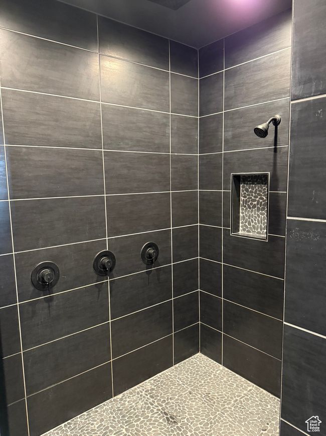 Bathroom featuring a tile shower | Image 12