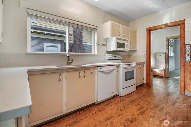 Luxury vinyl plank flooring flows throughout the kitchen & dining area. | Image 11