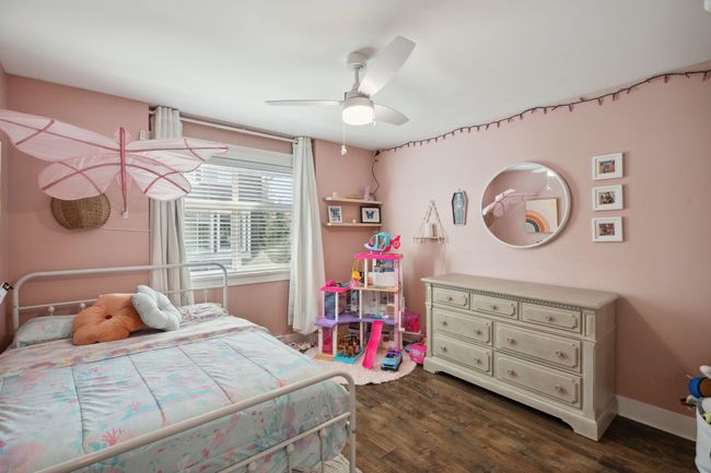 Bedroom featuring dark wood-style flooring, baseboards, and ceiling fan | Image 21
