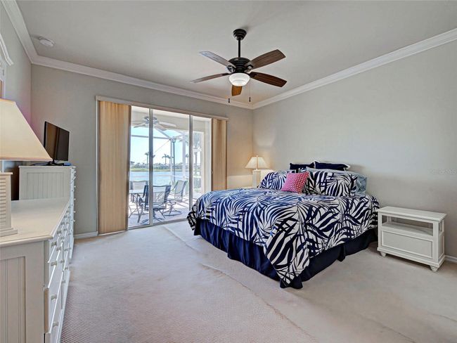 Primary bedroom with water view through sliders | Image 28