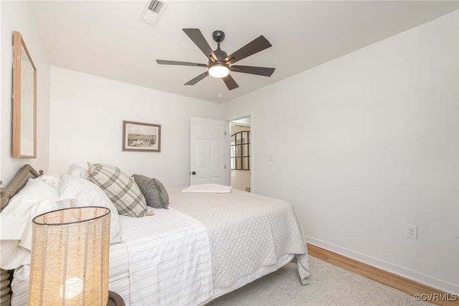 Bedroom featuring baseboards, visible vents, wood finished floors, and a ceiling fan | Image 22