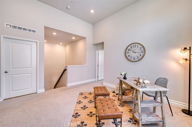 Bright and versatile 2nd floor loft with shiplap accents and high ceilings. | Image 13