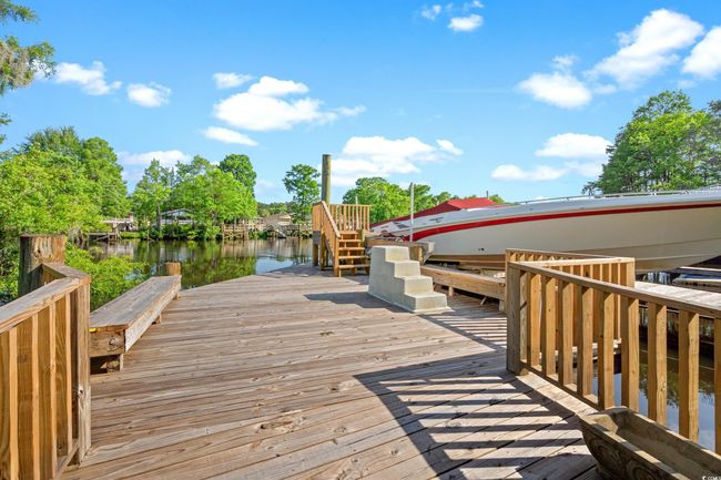Wooden deck featuring a water view and a boat dock | Image 32
