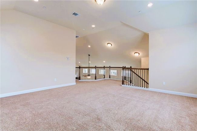 Carpeted spare room with vaulted ceiling, baseboards, and recessed lighting | Image 6