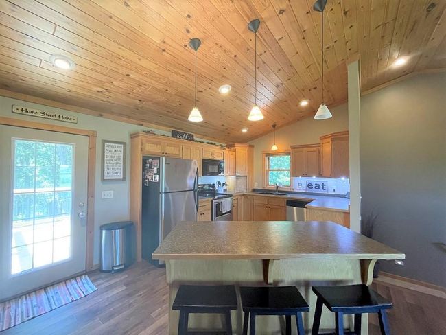 Spacious kitchen with door to large deck. | Image 6