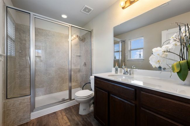 Full bathroom with a stand in shower and featuring vanity. | Image 23