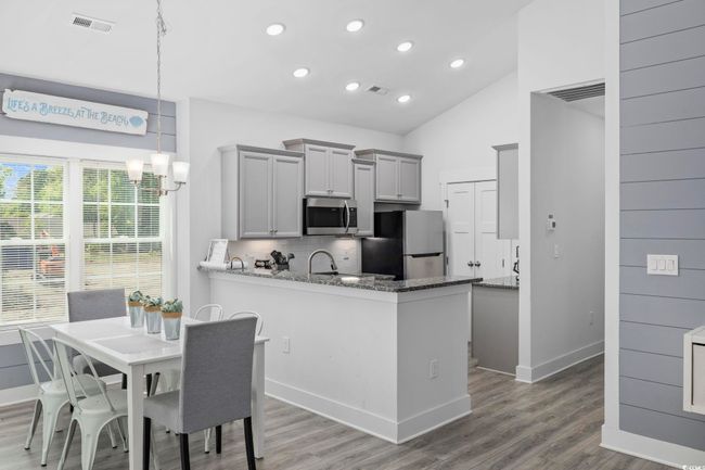 Kitchen featuring gray cabinetry, wood finished floors, stainless steel appliances, and a sink | Image 7