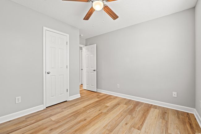 Unfurnished bedroom with light wood-style floors and ceiling fan | Image 23