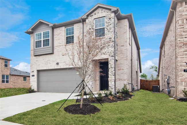 View of front of house featuring a garage, driveway, and brick siding | Image 31
