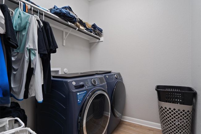 Laundry room with independent washer and dryer and wood finished floors | Image 15