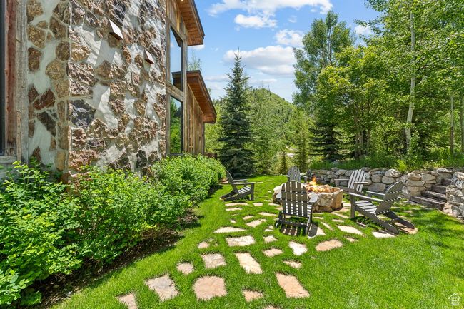 View of green lawn with an outdoor fire pit | Image 52