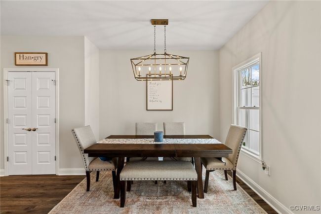 Dining room featuring a chandelier and dark hardwood / wood-style floors | Image 38