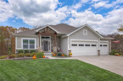 Craftsman-style house featuring a garage and a front yard | Image 1