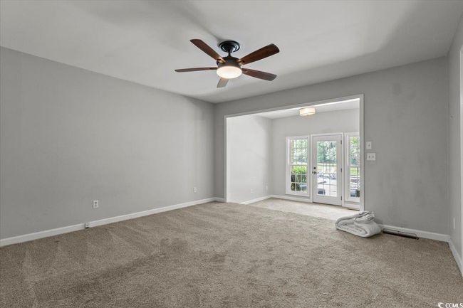 Carpeted empty room featuring ceiling fan and baseboards | Image 24