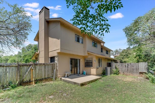 Back of property featuring a patio, a chimney, a gate, and central AC unit | Image 14