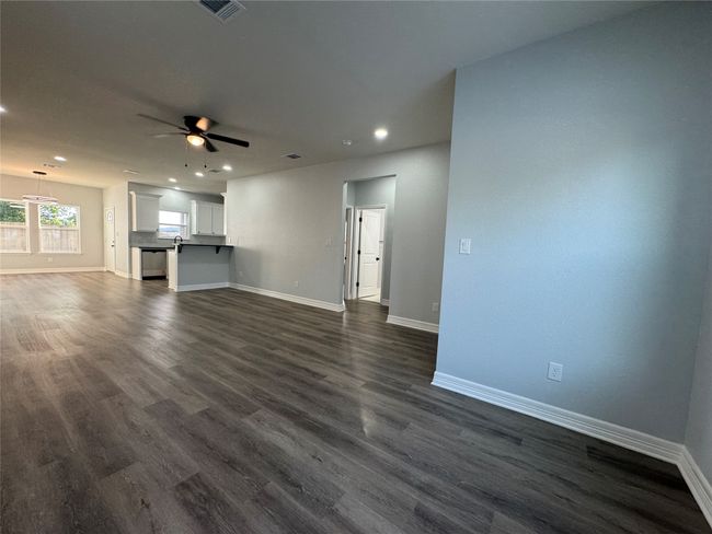 Unfurnished living room featuring recessed lighting, ceiling fan, and dark wood-type flooring | Image 5