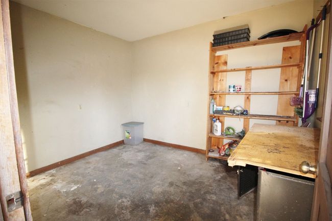 Large storage room on back of home under patio | Image 32