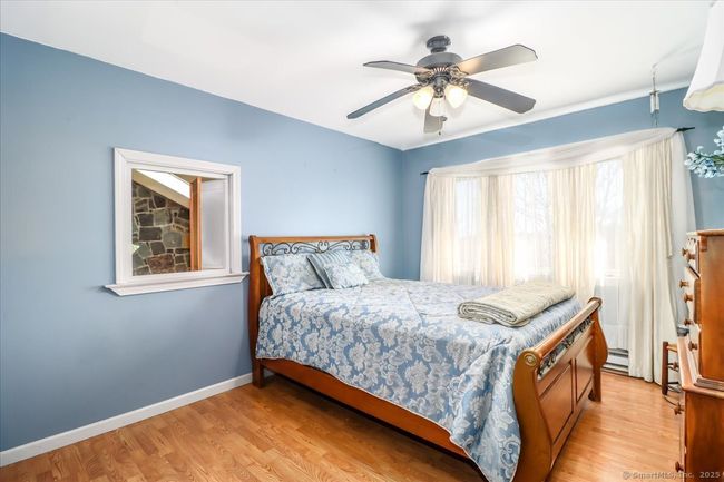 The first bedroom has a peek-a-boo window looking into the living room. | Image 30
