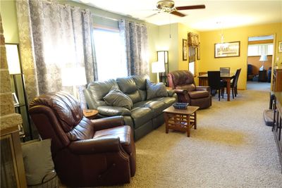 Spacious Living Room with Brick Fireplace and Picture Window | Image 2