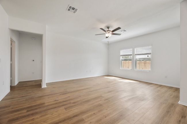 Spare room with a ceiling fan and wood finished floors | Image 16