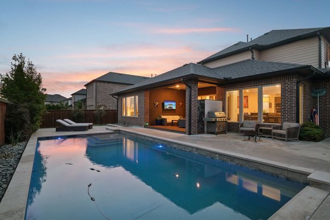 View of pool featuring an outdoor hangout area, area for grilling, a patio, and a fenced backyard | Image 30