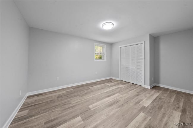 Unfurnished bedroom featuring light wood-type flooring, baseboards, and a closet | Image 33
