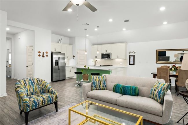 Living area with recessed lighting, wood finished floors, and visible vents | Image 16