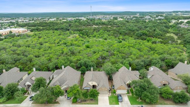 Aerial perspective of suburban area featuring a heavily wooded area | Image 37