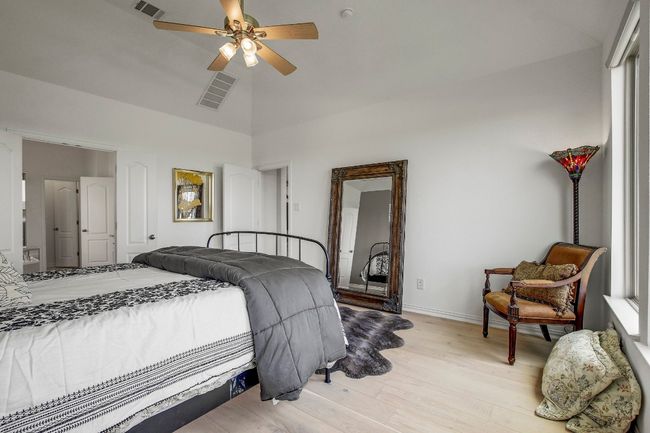 Bedroom featuring light wood-style floors, high vaulted ceiling, and ceiling fan | Image 18