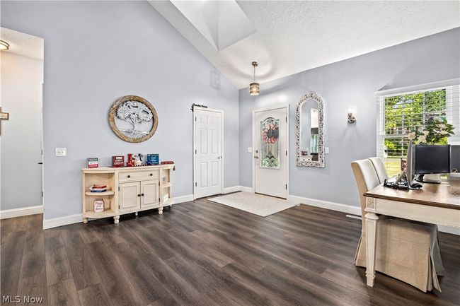 Office area with dark hardwood / wood-style floors, high vaulted ceiling, and a textured ceiling | Image 5