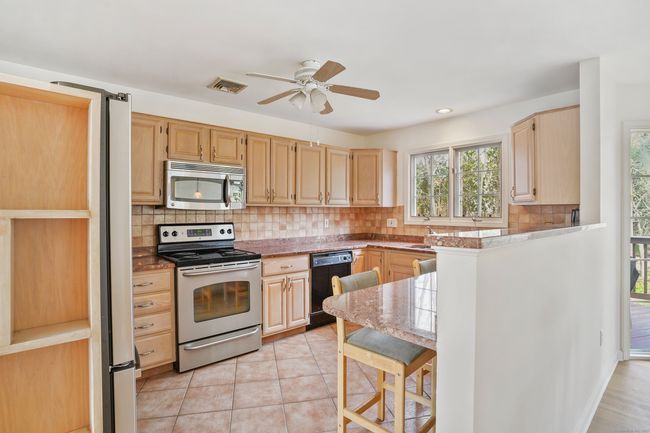 Kitchen with breakfast bar, granite countertops | Image 4